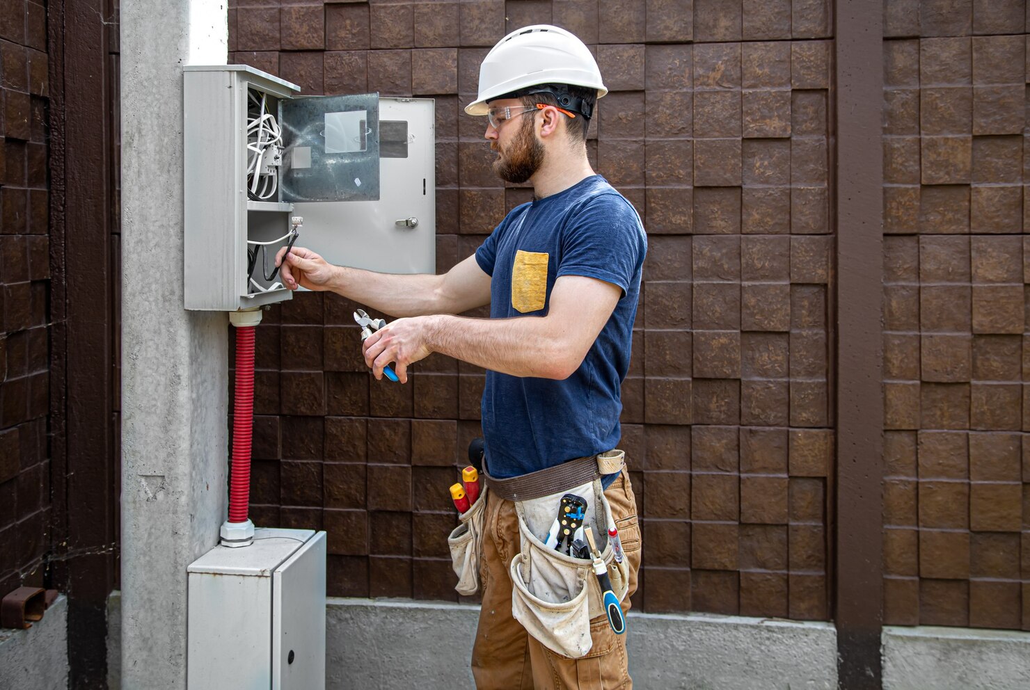 Local commercial electrician inspecting electrical panel for safety and maintenance