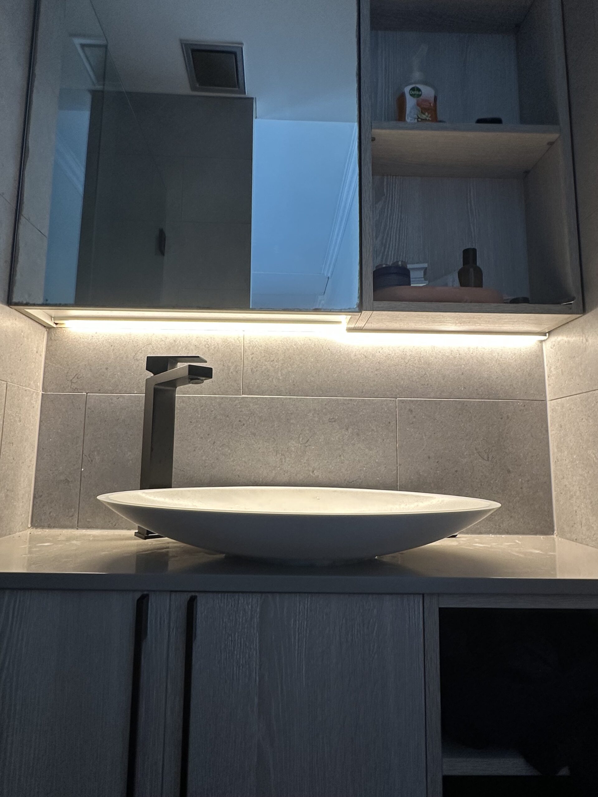 Electrician installing safe, moisture-rated bathroom lighting