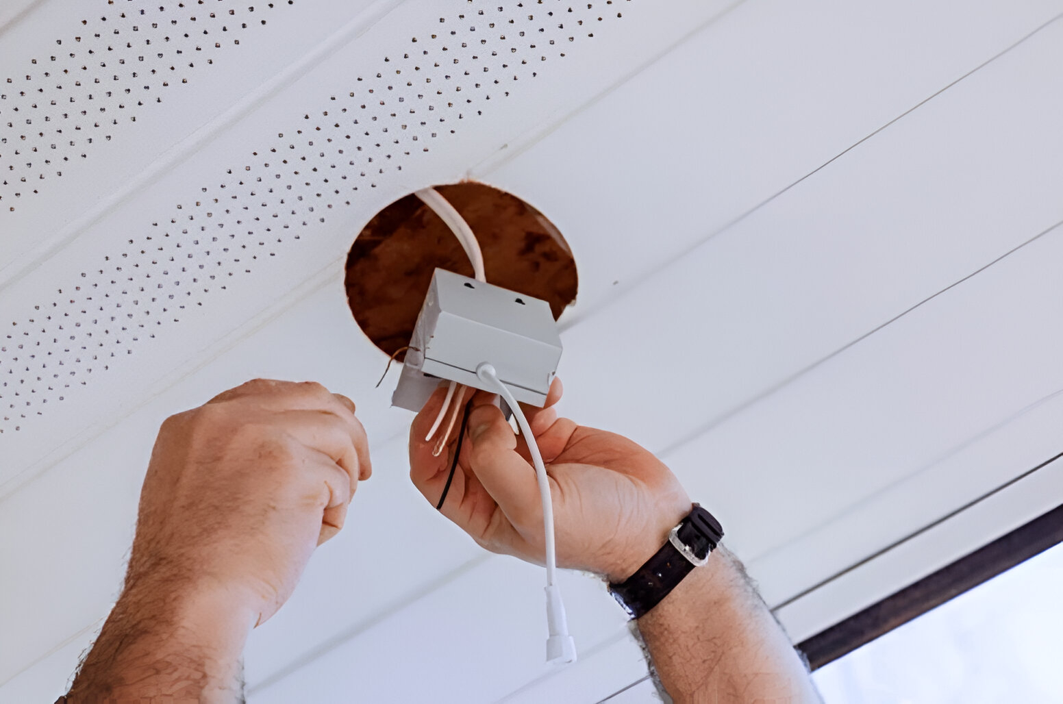 Electrician checking wiring and transformers before lighting upgrade