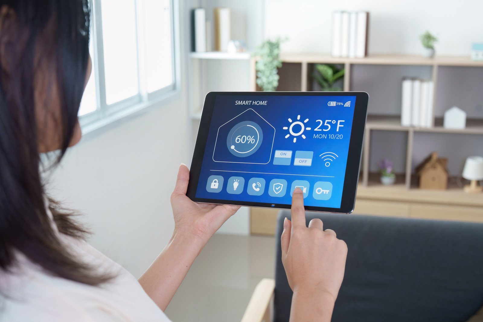 Lady controlling home appliances with tablet