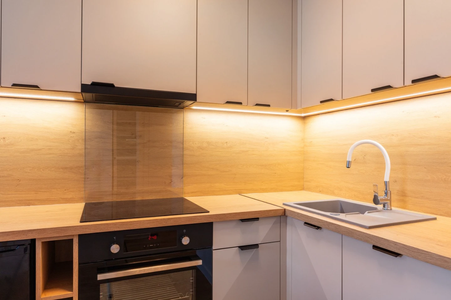 A modern kitchen featuring 4000K neutral white LED task lighting under cabinets for better visibility.
