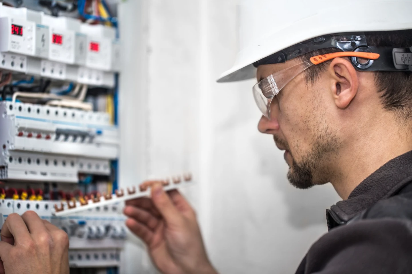 A licensed Level 2 electrician performing a high-voltage switchboard upgrade and smart meter installation.