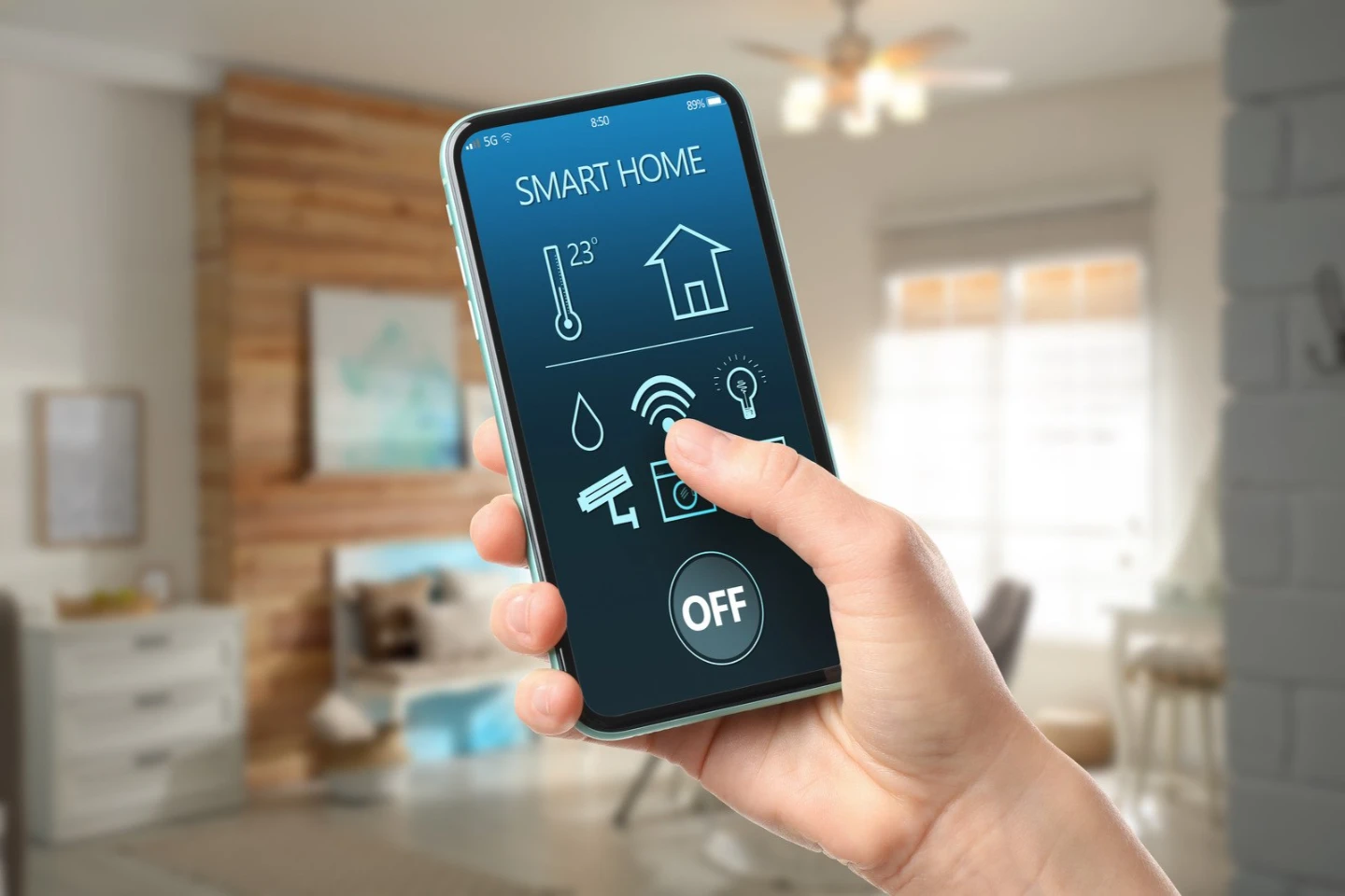 A homeowner using a smartphone app to adjust the colour temperature of a smart LED bulb in a Victorian home.