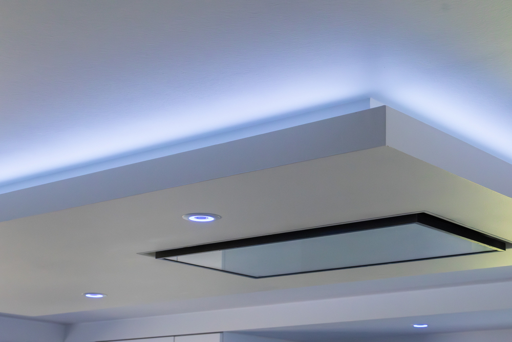 Modern ceiling with recessed downlights, glass feature, and blue LED strip lights along the edges.